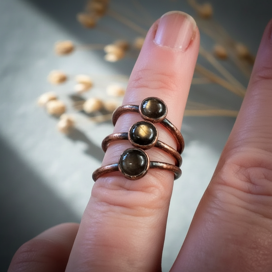 Black moonstone hand shot on light grey slate