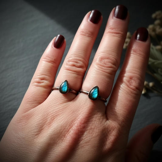 Labradorite two-finger hand shot on dark charcoal slate