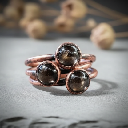Black moonstone close-up cluster on light grey slate