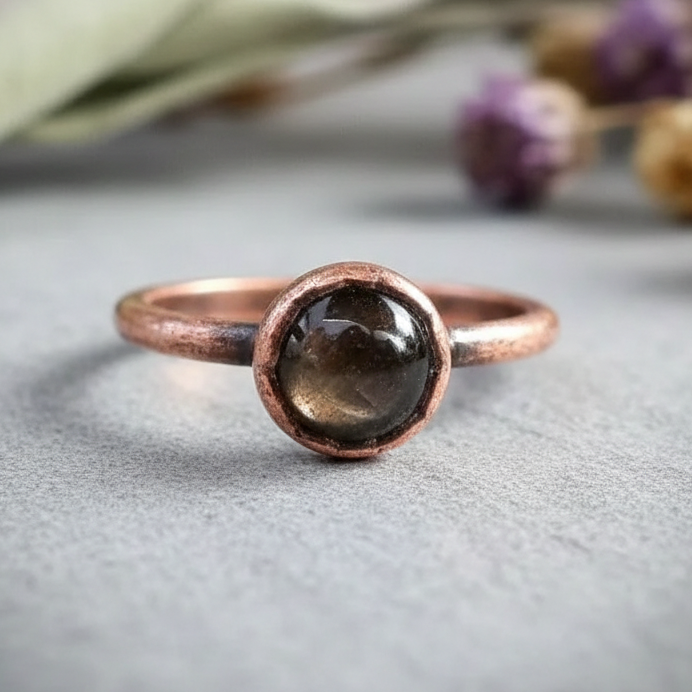 Black moonstone single ring hero on light grey slate