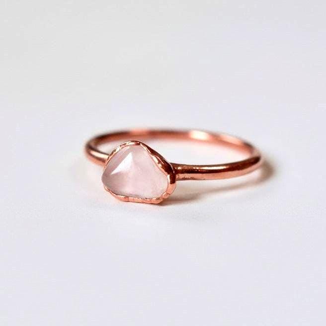 Close-up of dainty rose quartz copper ring showing natural pink stone and warm copper band