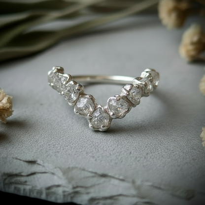 Raw clear quartz silver-plated chevron ring side angle on light grey slate