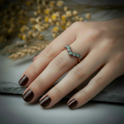 Raw clear quartz chevron ring hand shot showing V-shape across the finger