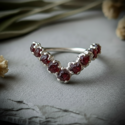 Raw garnet silver-plated chevron ring hero close-up on light grey slate