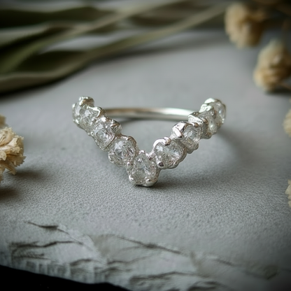 Raw clear quartz silver-plated chevron ring hero close-up on light grey slate