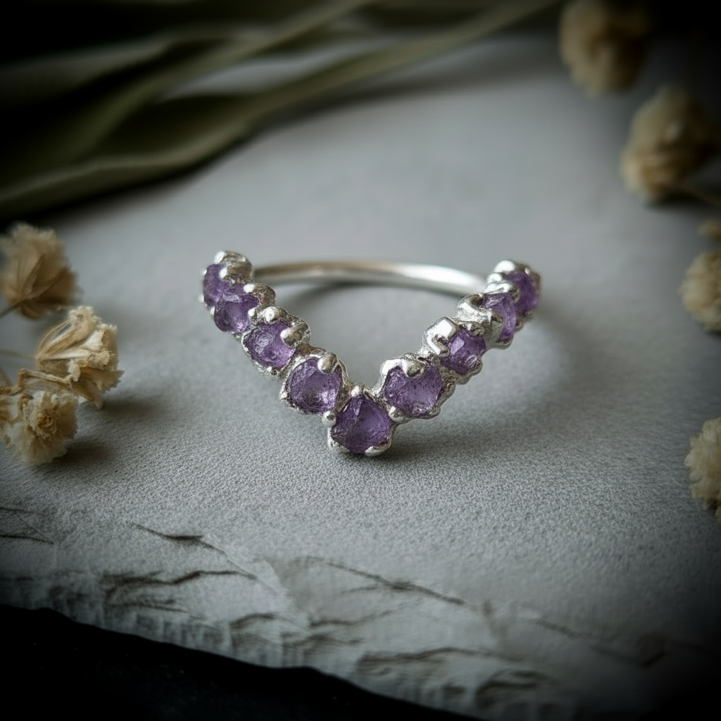 Raw amethyst silver-plated chevron ring flat lay overhead on light grey slate