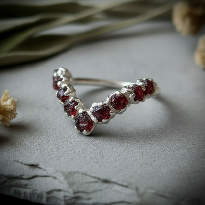 Raw garnet silver-plated chevron ring side angle on light grey slate