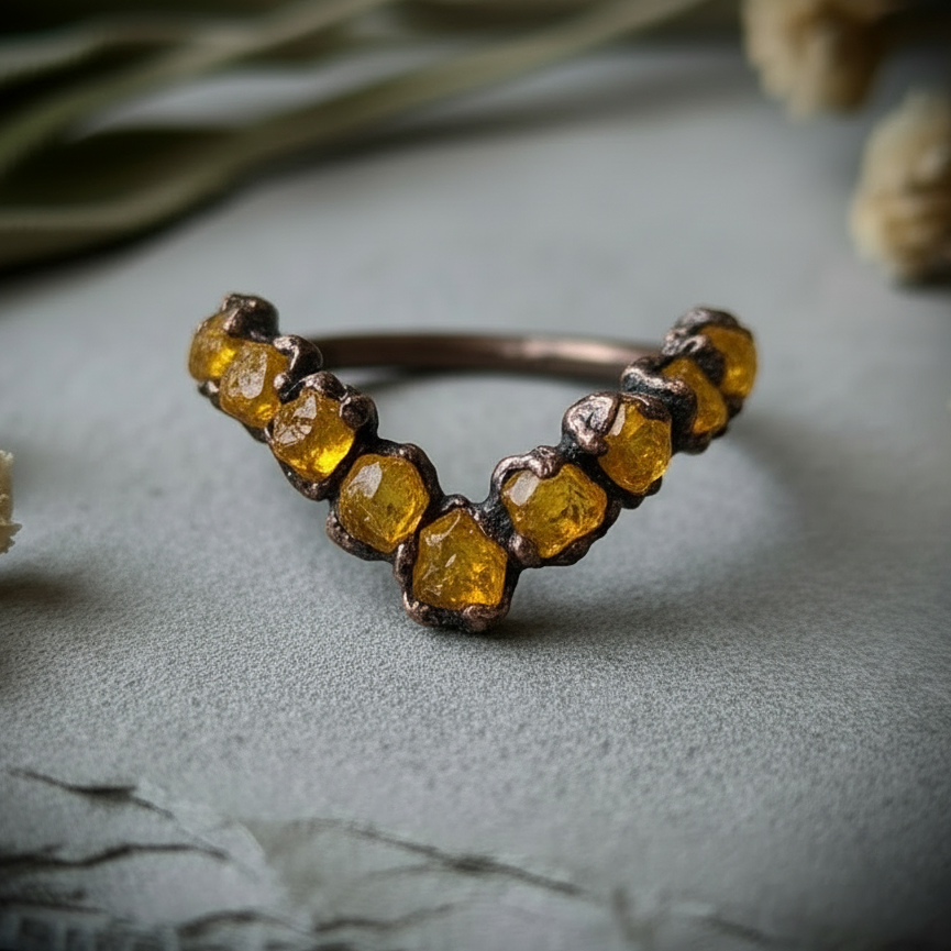 Raw citrine chevron ring close-up detail showing dark antique copper bezels and warm golden amber citrine stones