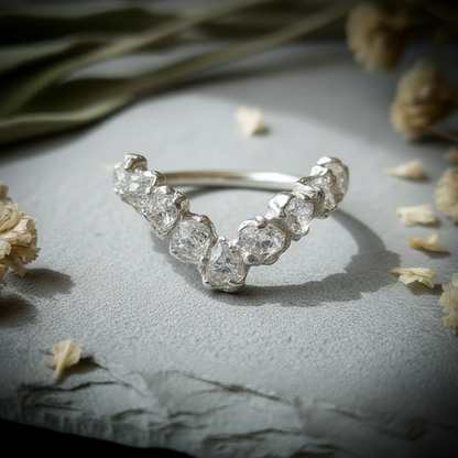 Raw clear quartz silver-plated chevron ring flat lay overhead on light grey slate