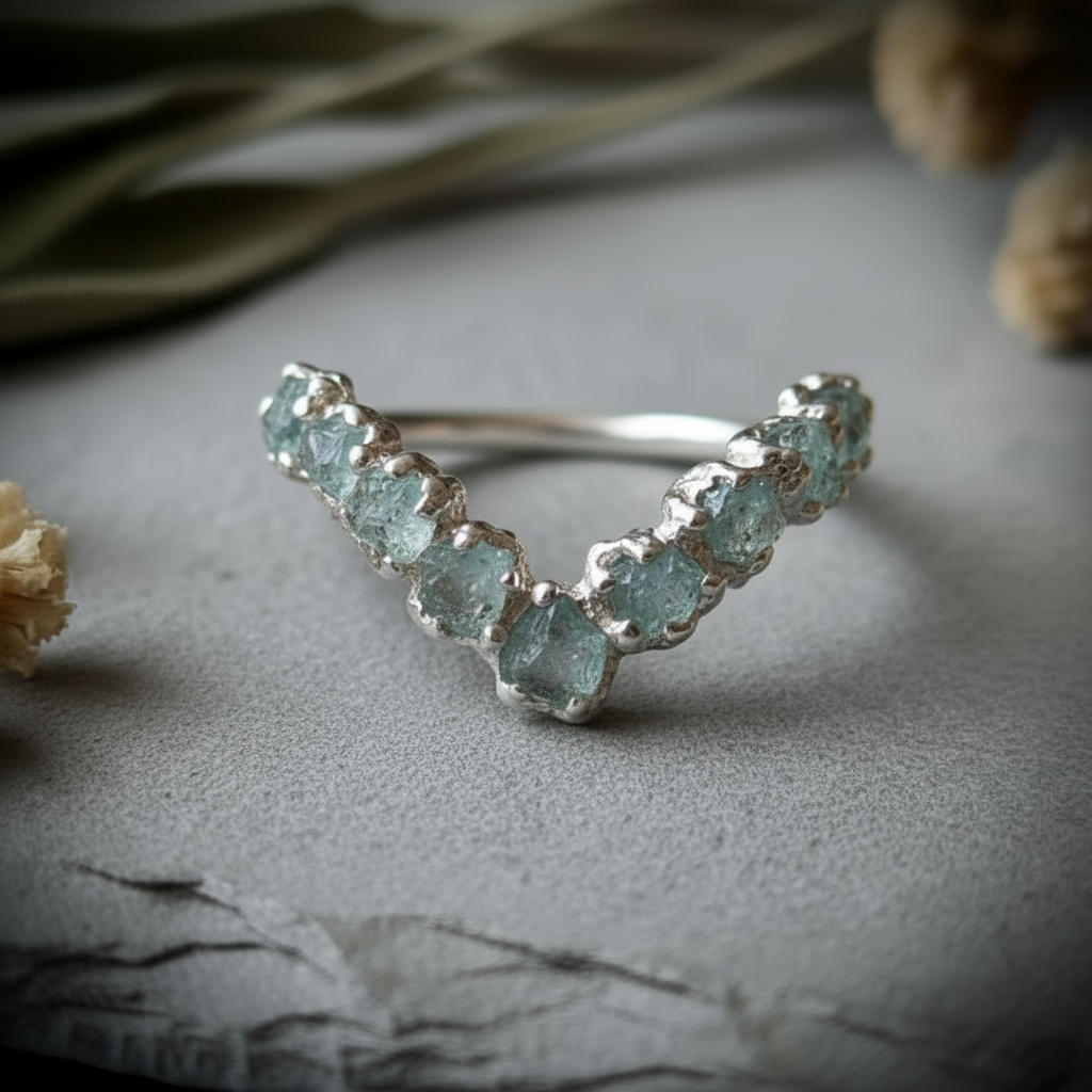 Raw aquamarine sterling silver chevron ring, top-down arc view showing all 9 stones