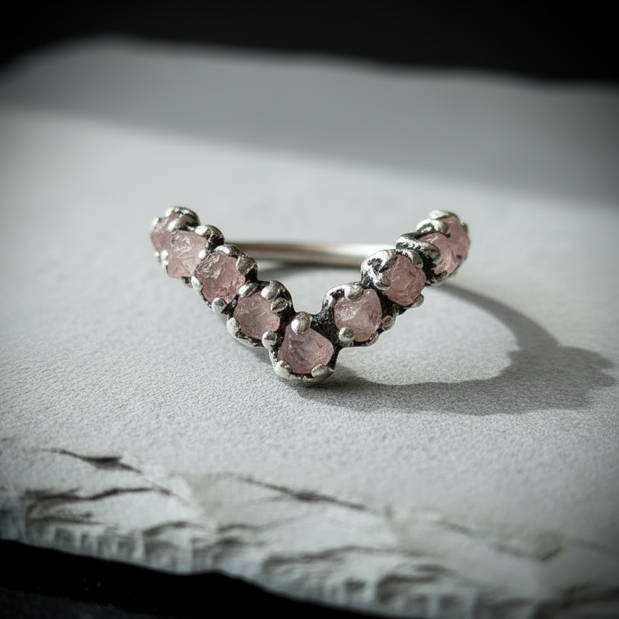 Raw rose quartz chevron ring in silver-plated copper on light grey slate, hero close-up