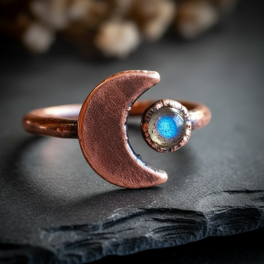 Labradorite crescent moon ring hero on dark charcoal slate