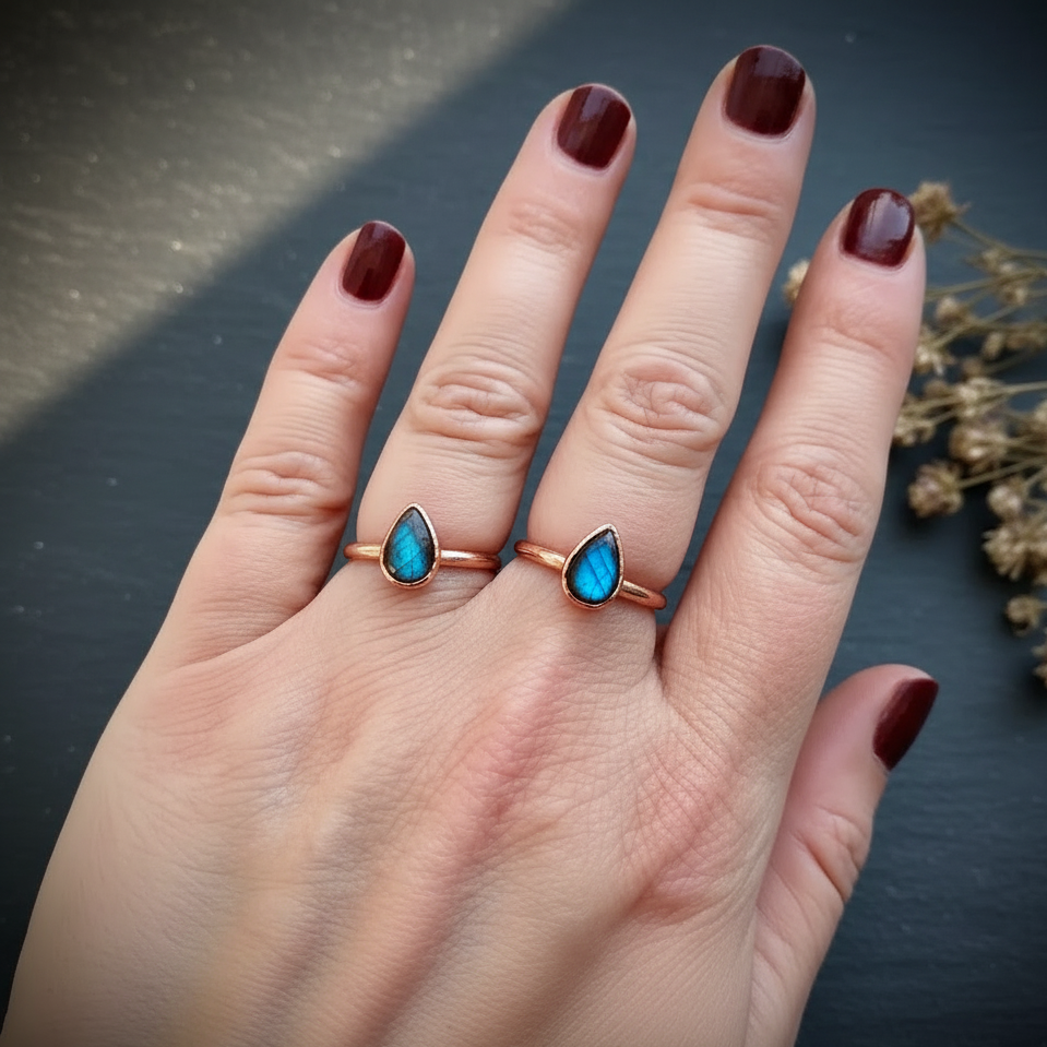 Labradorite three-finger hand shot on dark charcoal slate