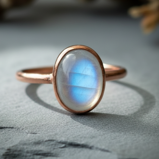 Moonstone ring hero close-up on dark slate