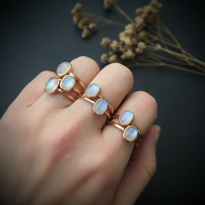 Moonstone rings hand shot on dark slate