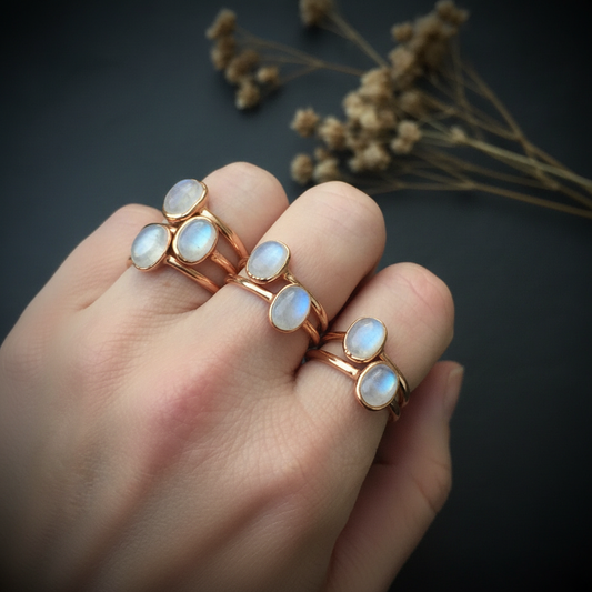 Moonstone rings hand shot on dark slate
