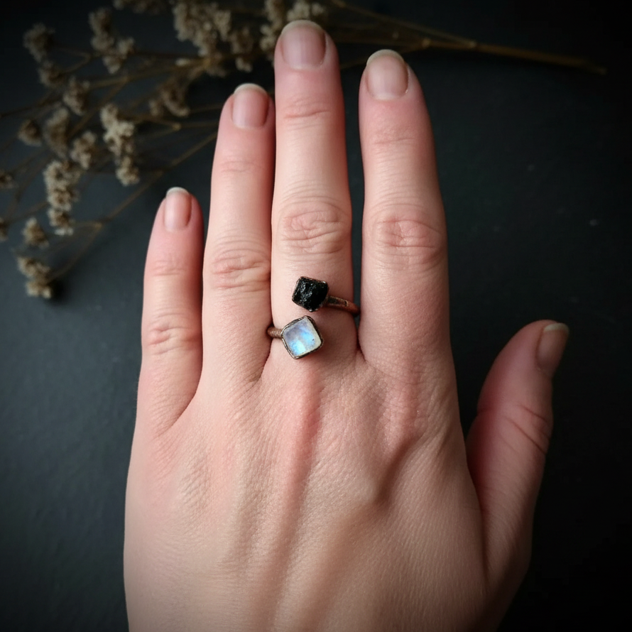 Moonstone tourmaline bypass ring hand shot 2 on dark charcoal slate