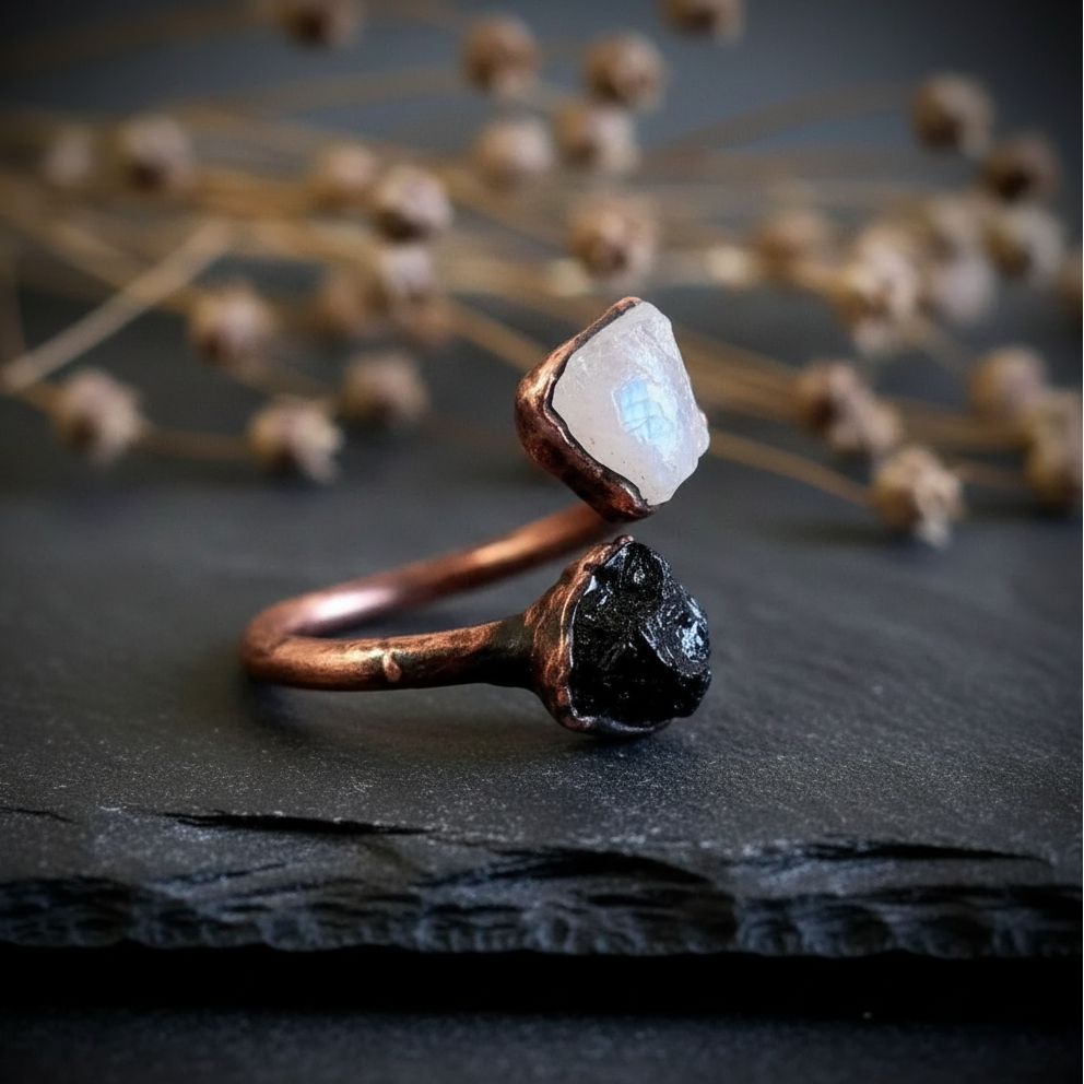 Moonstone tourmaline bypass ring side profile on dark charcoal slate