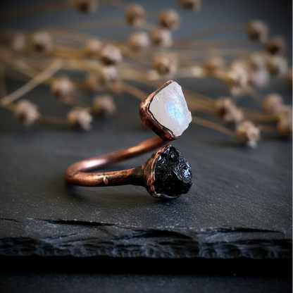 Moonstone tourmaline bypass ring side profile on dark charcoal slate