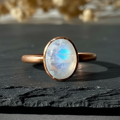 Oval moonstone extreme close-up on dark charcoal slate